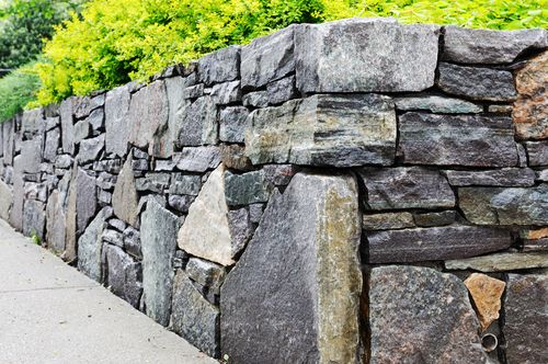 up close image of stone masonry rock wall 